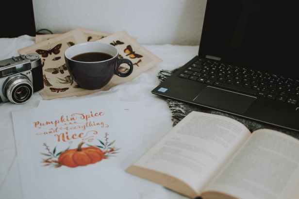 cup of coffee near laptop computer